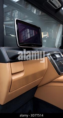Interior view of luxury car showing touchscreen display and leather seating Stock Photo