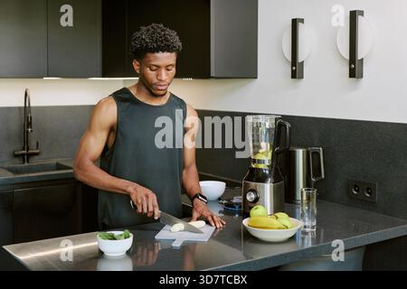 Young Adult Black Man Preparing Healthy Breakfast in Modern Kitchen Morning Stock Photo
