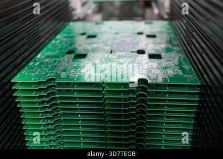Closeup view of stack of green printed circuit boards in modern electronics manufacturing plant concept of technology industry production Stock Photo