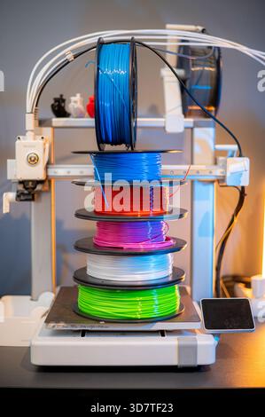 Many multi-colored spools of thread of filament for printing 3d printer. Material coils for printing 3D printer. Spools of 3D printing motley differen Stock Photo