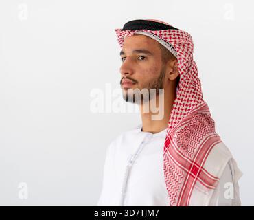 Close up portrait of man wearing traditional arabic clothing, standing against white background. High quality photo Stock Photo