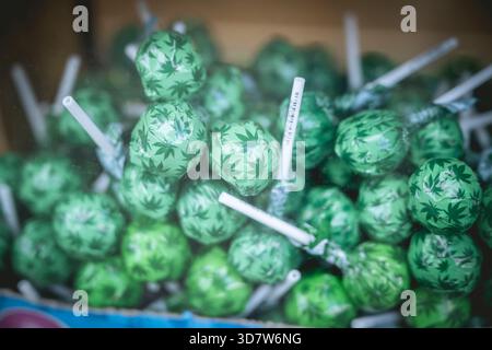 Green lollipops with marijuana leaf patterns in a box. Amsterdam,. Netherlands Stock Photo