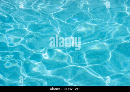 Light blue water reflecting sunlight in swimming pool Stock Photo