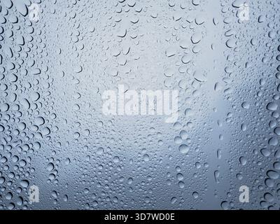 Close-up of raindrops on windowpane glass Stock Photo
