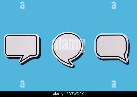 Blank white thought bubbles on blue background Stock Photo