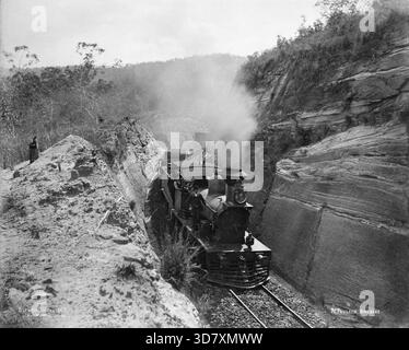 Toowoomba Range engine Murphy's Creek and Highfields, c1894. A steam locomotive coming through a cutting on the Toowoomba Range between Murphy's Creek and Highfields. Three men are depicted, probably the driver and the fireman. Stock Photo