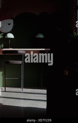 Moody Minimalist Interior with Sunlight and Dark Green Wall Stock Photo