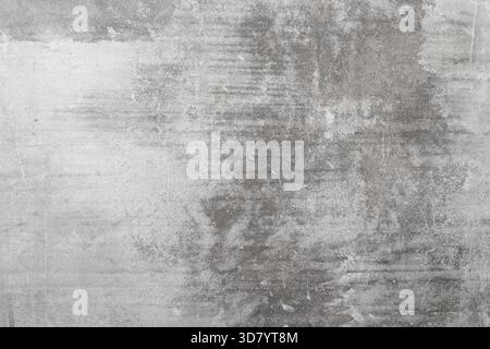 A medium gray concrete surface features subtle horizontal scratches and an overall distressed texture, a background in an industrial, minimalist style. Stock Photo
