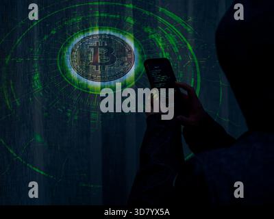 Hacker with smartphone targeting Bitcoin in futuristic green cyber interface Stock Photo