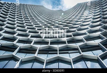 Low angle view of distinctive hexagonal facade of the DUO Tower (part of the DUO development) in Singapore. Ole Scheeren architect curved walls Stock Photo