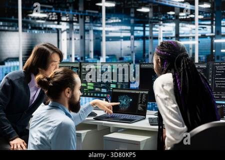 Server farm IT coworkers doing brainstorming, deploying AI tools to automate repetitive workflows. Data center technicians cooperating to manage datasets used in AI training, streamlining tasks Stock Photo