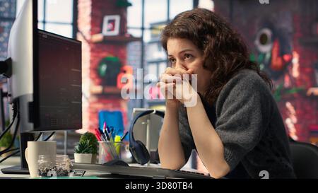 Devastated sad woman losing financial value on stock trading platform, crying and being stressed following market crash. Worried overwhelmed investor deals with monetary losses. Camera B. Stock Photo