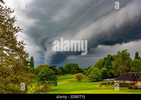 Ominous storm clouds gather over a residential neighborhood in Calcot, Reading, during a period of unsettled weather in Berkshire. Stock Photo