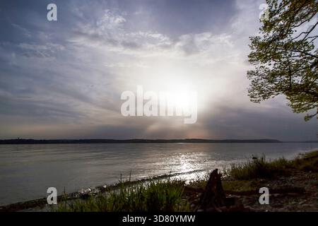 cirrus clouds in front of the low sun over Lake Constance, Germany, Baden-Wuerttemberg, Meersburg Stock Photo