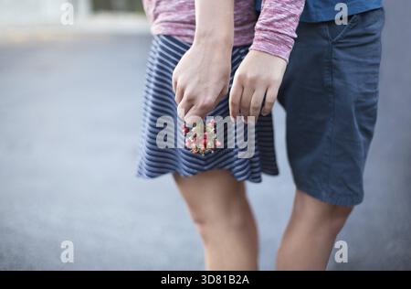 Conceptual image of female and male hands together, hipster couple Stock Photo