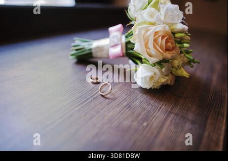Wedding bouquet and ring on wooden background Stock Photo
