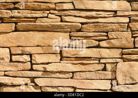 Sand colored stone setting. Stone wall texture Stock Photo