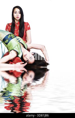 Studio portrait of two beautiful Mixed-race vietnamese sisters Stock Photo