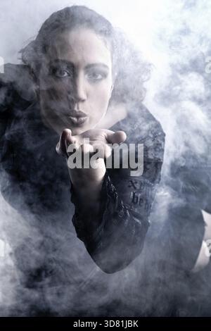 Portrait of a woman with long curly hair blowing Stock Photo