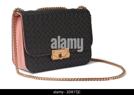 woven black leather crossbody bag with pink sides, elegant shoulder purse with gold chain isolated white background, fashion accessory with turn-lock Stock Photo