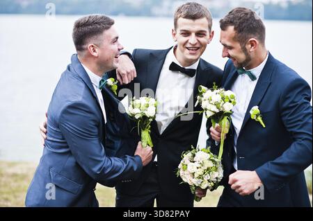 Three friends, groom with groomsman having fun Stock Photo