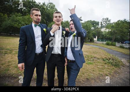 Three friends, groom with groomsman having fun Stock Photo
