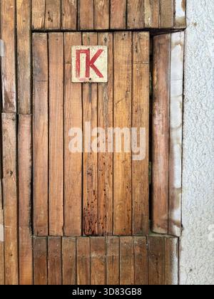 Russian language sign reading "PK" for "fire hydrant" on wooden door Stock Photo