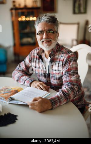 Smiling older man enjoying a quiet moment Stock Photo