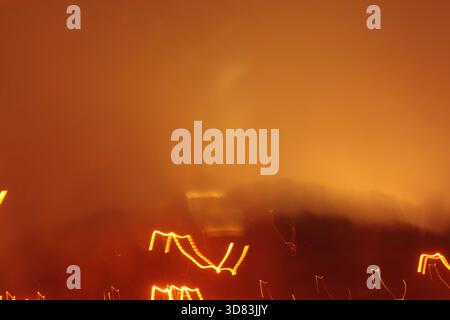 A warm and foggy abstract background with an orange and yellow glow, creating a moody, atmospheric scene. Stock Photo
