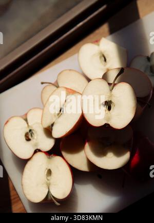 Close-Up of Vibrant Apple Halves in Natural Light Stock Photo