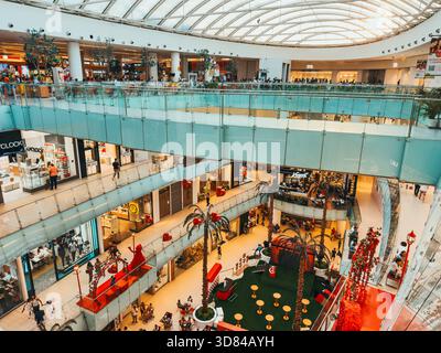 Interior of Ágora Mall in Santo Domingo, Dominican Republic, featuring multiple levels, modern design, shops, and festive decorations Stock Photo
