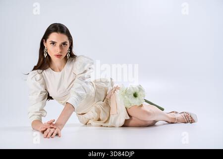 A beautiful bride in a stunning white dress poses elegantly, radiating timeless beauty. Stock Photo