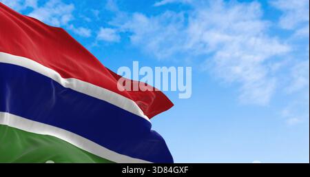 National flag of the Gambia waving in the wind on a clear day. Three horizontal red, blue, and green bands, separated by two narrow white bands. 3d illustration render. Fluttering fabric Stock Photo