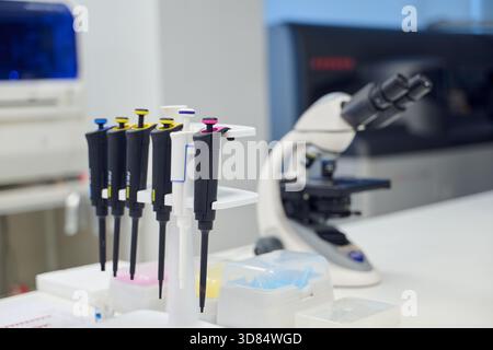 Laboratory scene with pipettes and microscope in a modern research facility Stock Photo