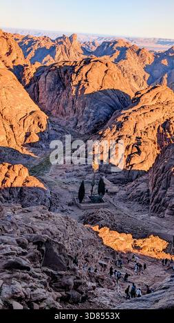 Dawn light over the red mountains of Mount Sinai, capturing the silent beauty of the desert peaks during the ascent to Moses’ Mountain Stock Photo
