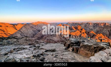 Dawn light over the red mountains of Mount Sinai, capturing the silent beauty of the desert peaks during the ascent to Moses’ Mountain Stock Photo