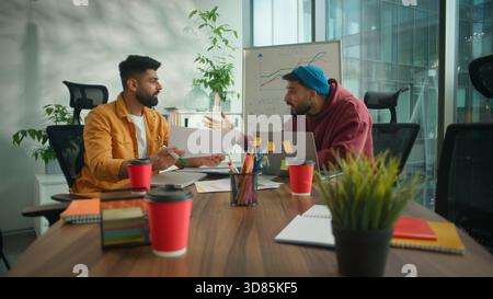 Two angry arguing fury talking Hindu business men conflict quarrel document bad result failure negative discuss corporate argue misunderstanding in Stock Photo
