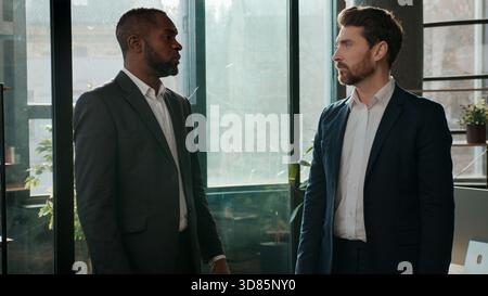 Diverse ethnic business men team businessmen talking formal communication in office male employers discussing project multiracial managers Stock Photo
