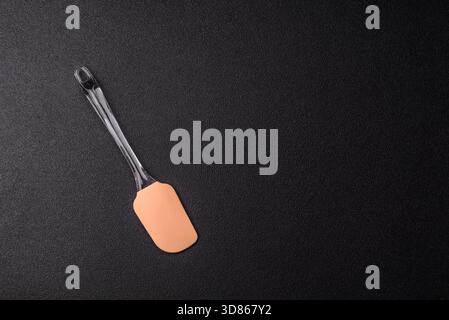 Spatula, silicone kitchen utensils for cooking and baking at home. Silicone spatula as a food background for your design Stock Photo
