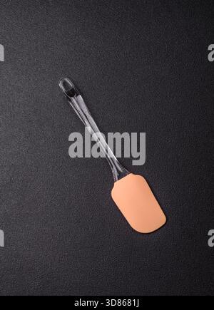 Spatula, silicone kitchen utensils for cooking and baking at home. Silicone spatula as a food background for your design Stock Photo