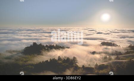 Aerial view of sunlight piercing through the clouds over Mount Tamalpais, creating a mystical landscape of light and shadow, Mount Tamalpais, Californ Stock Photo