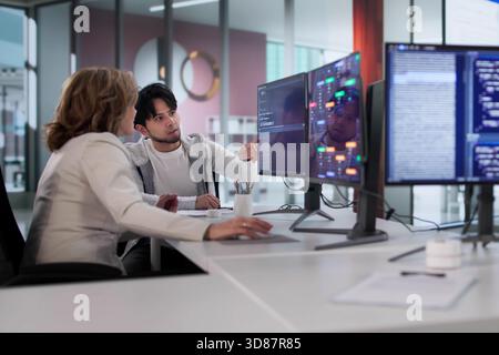 Diverse Agile Team Of Programmers Coding In Office Workplace Together. Stock Photo