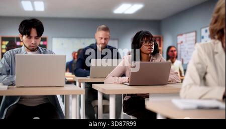 Multiethnic Students Smiling In University Classroom Taking American History Test Stock Photo