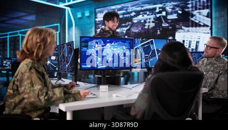 Military Data Center: A Diverse Team Monitoring Intelligence Using Computers. Stock Photo