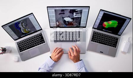 Top Digital Designer Developing Battery Pack Simulation On Personal Laptop. Stock Photo