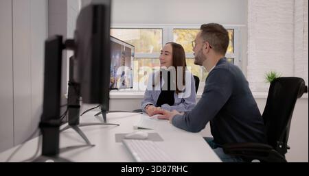 Female Graphic Designers Working On Computer For Print And Web Projects. Stock Photo