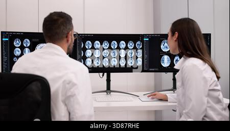 Female Neurologist Monitoring Brain Scan On Desktop Computer Screen ...