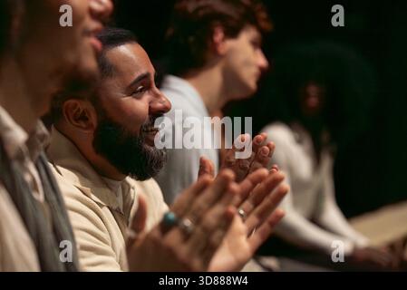 Happy bearded man clapping while enjoying play in stage theater Stock Photo