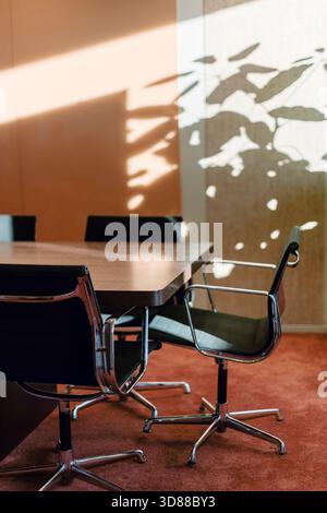 Empty chairs at conference table in law office Stock Photo