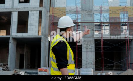 A construction foreman conducts an inspection at a construction site Stock Photo